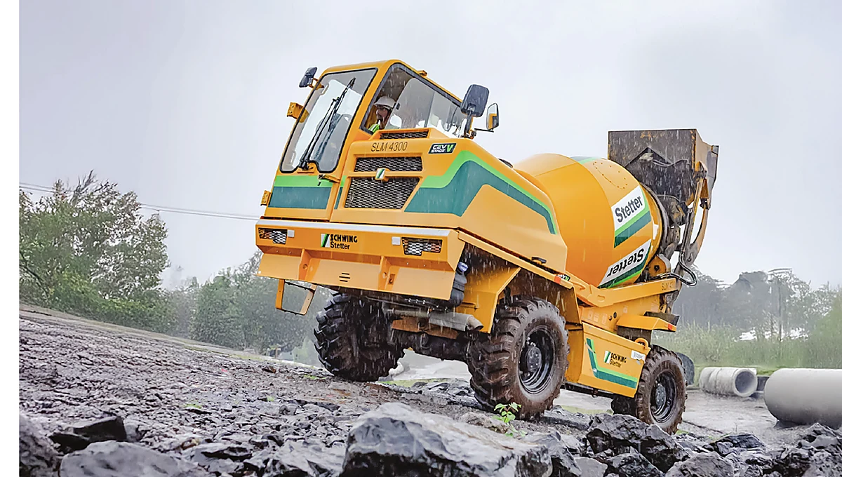 Self-loading mixer travelling across a rough job site